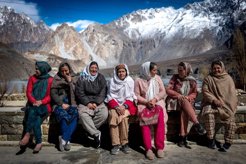 People standing in front of a mountain in traditional dress