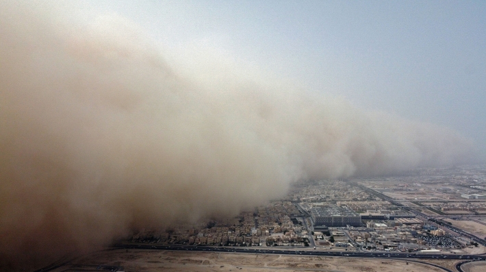 A dust storm envelops a city