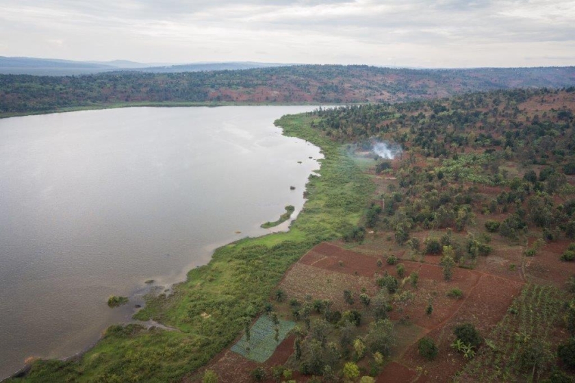 An aerial shot of a lake surrounded by hills  