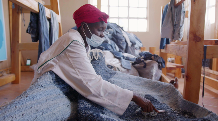 A woman working on textile